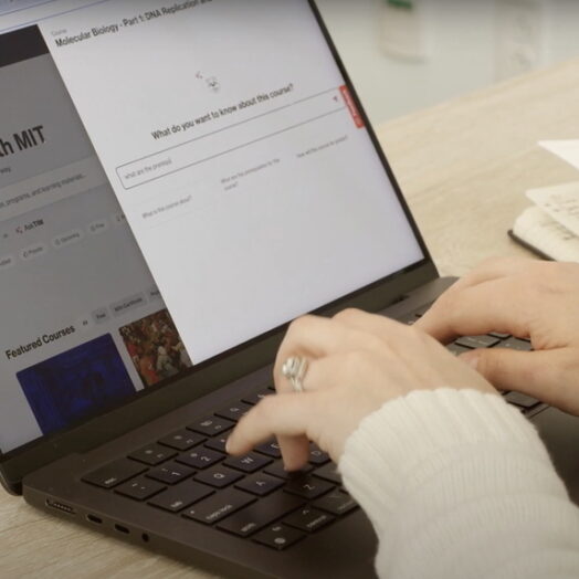 Hands typing a laptop with the MIT Learn homepage shown