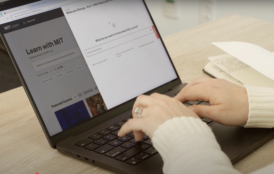 Hands typing a laptop with the MIT Learn homepage shown