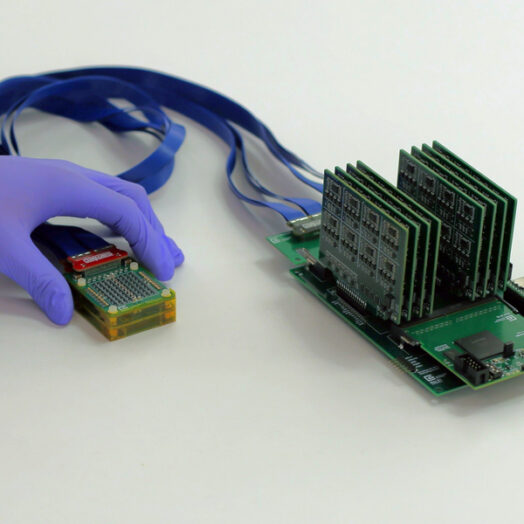 The complete setup shows, on left, the ultrasound prototype connected by wires to exposed circuit boards.