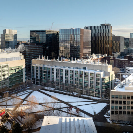 Aerial view of the MIT campus in winter, with Kendall Square in the background