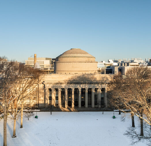 Aerial photo of the MIT Dome and Killian Court with snow on the lawn