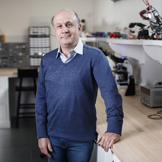 David Siegel standing in a robotics lab