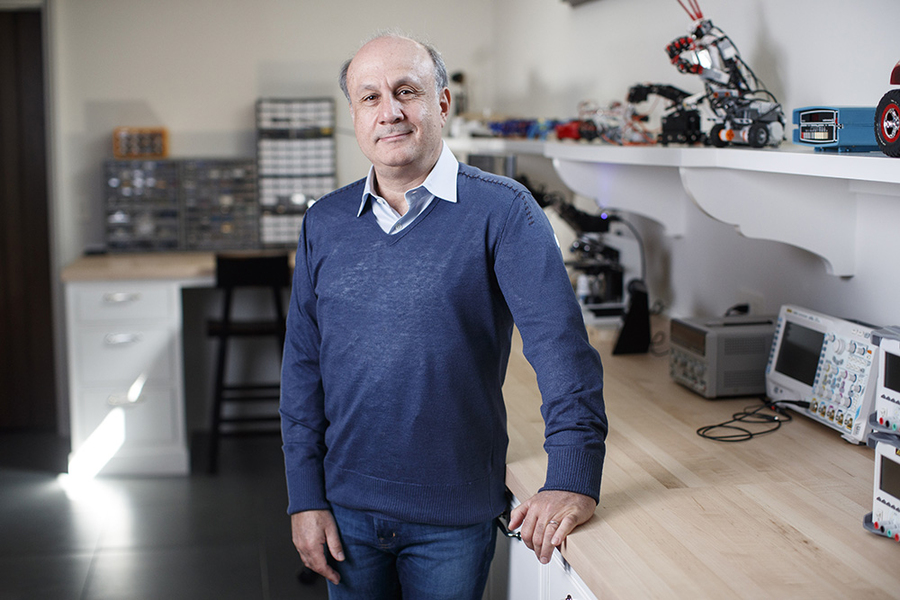 David Siegel standing in a robotics lab