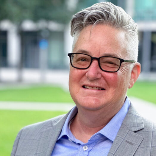 Chris Bourg headshot with MIT couryard in the background